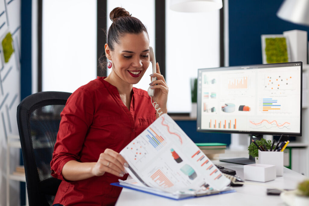 Businesswoman In Company Office Checking Finaicial Statistics - RW Office