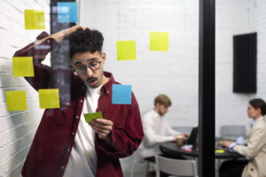 Medium Shot Man Holding Post It - RW Office