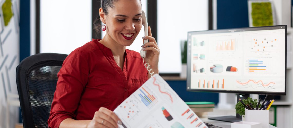 Businesswoman In Company Office Checking Finaicial Statistics - RW Office